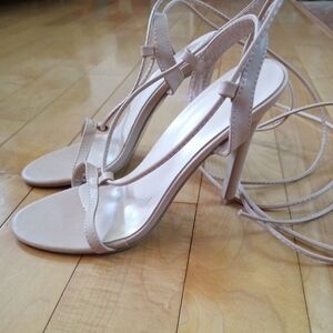 Nude t-strap stiletto heels that wrap up your leg. Women's size 40 USA size 9
